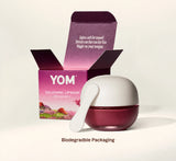 YOM 526 Loving Lip Mask in a dark berry jar with a white lid and applicator, shown next to its open packaging box on a light beige background with the text 'Biodegradable Packaging' below.